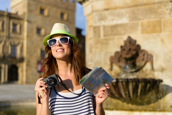 Woman tourist holding a camera and map Stock Photo