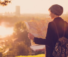 Woman tourist looking at city map Stock Photo 02