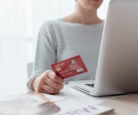 Woman using laptop for payment Stock Photo