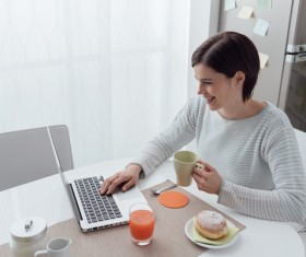 Woman using laptop online at home Stock Photo 03