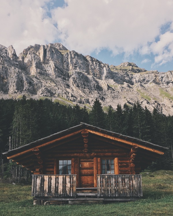 Wooden cottage on mountain landscape Stock Photo