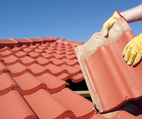 Worker repairing the roof Stock Photo 02