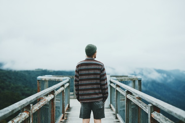 Young man watching mountain landscape Stock Photo
