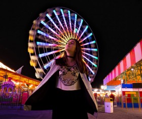 Young woman posing in amusement park Stock Photo