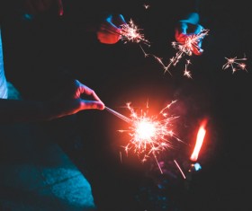 hands cheering with fireworks candles Stock Photo