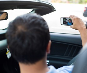 man who uses smartphone to take pictures Stock Photo