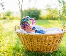 A baby sleeping in a wicker basket Stock Photo (2)