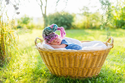 A baby sleeping in a wicker basket Stock Photo (2)