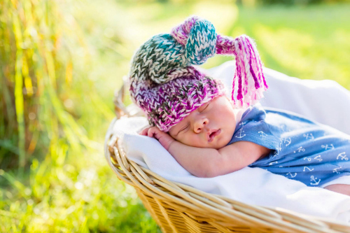 A baby sleeping in a wicker basket Stock Photo (3)