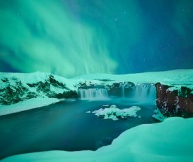 Amazing snowy waterfall landscape at dusk Stock Photo