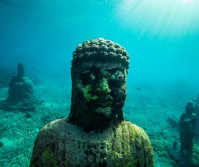 Ancient stone buddha statues under sea Stock Photo