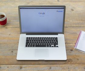 Apple laptop and coffee on desktop Stock Photo