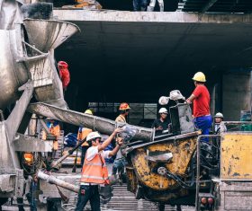 Asian workers on busy construction site Stock Photo