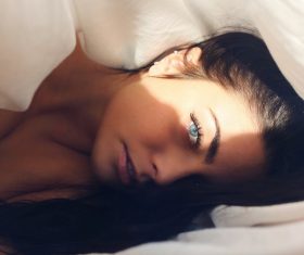 Attractive caucasian woman posing on bed Stock Photo