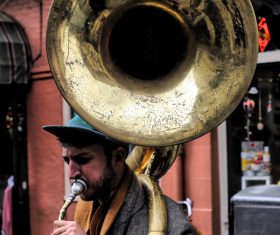Bearded man performing with big trumpet on road Stock Photo