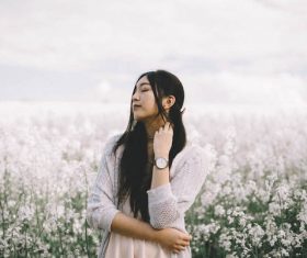 Beautiful asian woman posing on flowers field Stock Photo