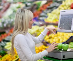 Beautiful housewife buying food in supermarket Stock Photo 01