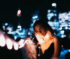 Beautiful young girl posing with bright lights Stock Photo