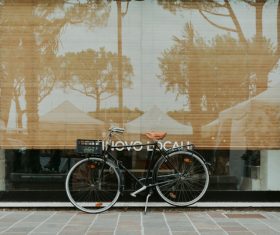 Bicycle leaning outside of glass door house Stock Photo