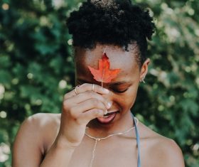 Black girl holding red leaf Stock Photo