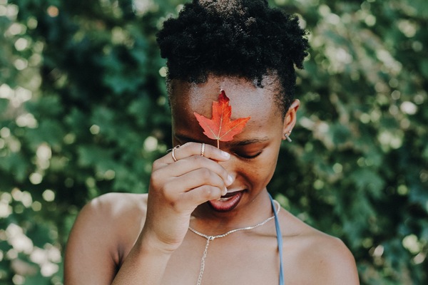 Black girl holding red leaf Stock Photo