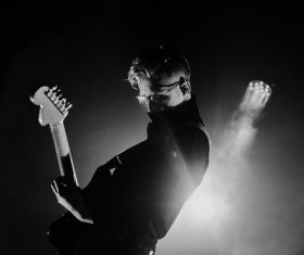 Black white picture of guitarist excited on stage Stock Photo
