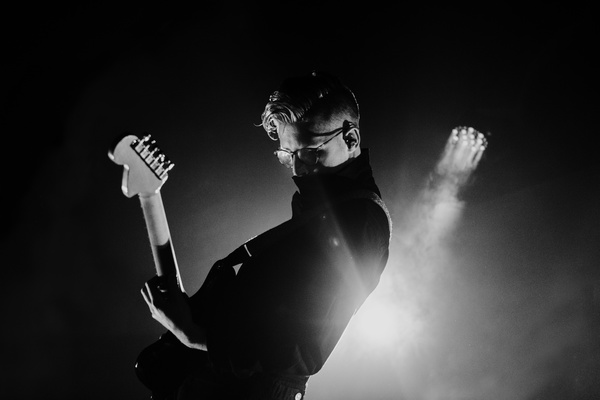 Black white picture of guitarist excited on stage Stock Photo
