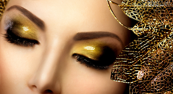 Closeup woman golden eye shadow Stock Photo