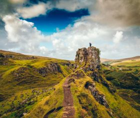 Clouds above green wide highland scenery Stock Photo