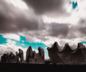 Cloudscape above artistic rocky shaped statues Stock Photo