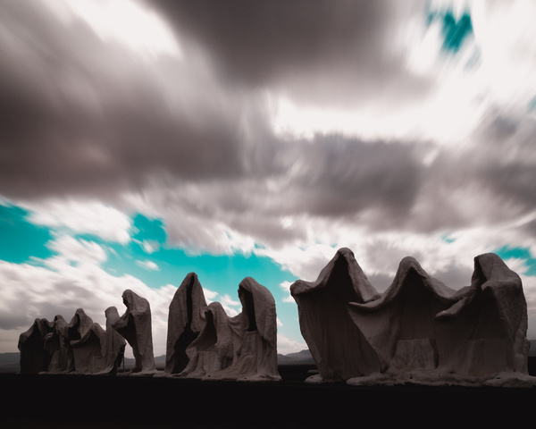 Cloudscape above artistic rocky shaped statues Stock Photo