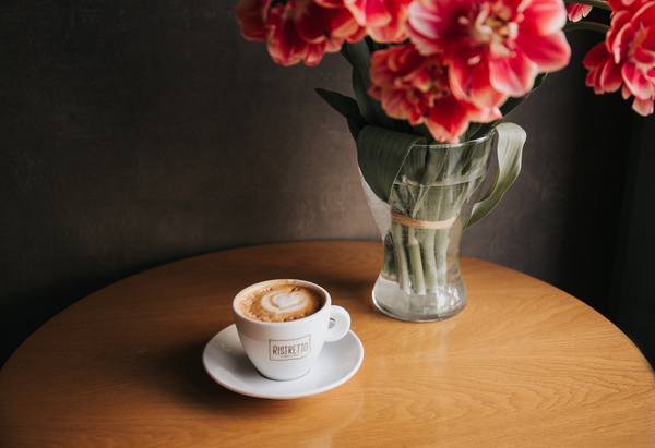 Coffee cup and decorative flowers on table Stock Photo