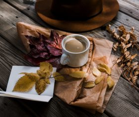 Coffee cup decorated with dried leaves Stock Photo