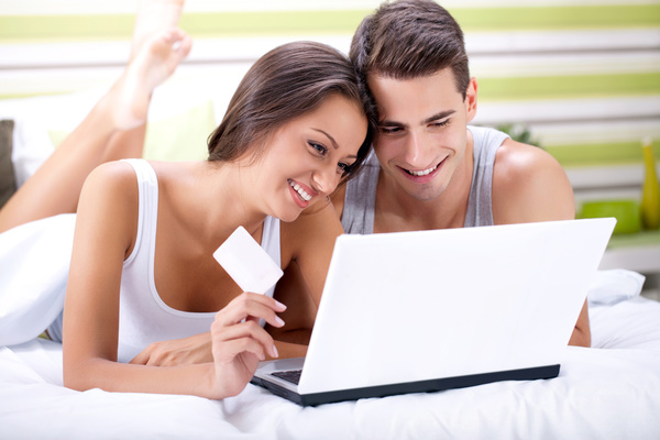 Couple shopping online together Stock Photo