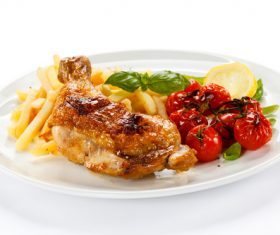 Delicious French fries and roasted chicken legs Stock Photo