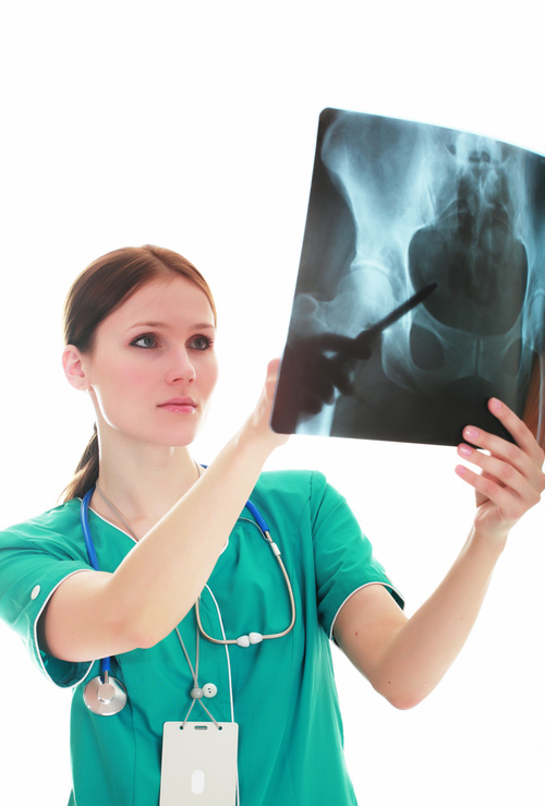 Female doctor viewing X-ray film Stock Photo