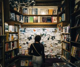 Girl standing in library looking at message sticker Stock Photo