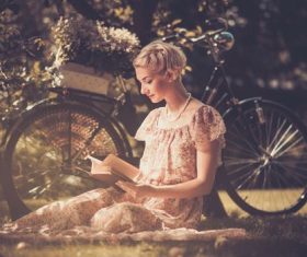 Girl with a bicycle resting in the bosom of nature Stock Photo (1)