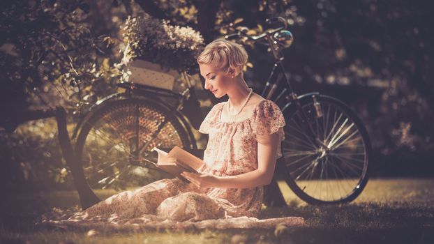 Girl with a bicycle resting in the bosom of nature Stock Photo (1)