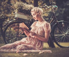 Girl with a bicycle resting in the bosom of nature Stock Photo (3)