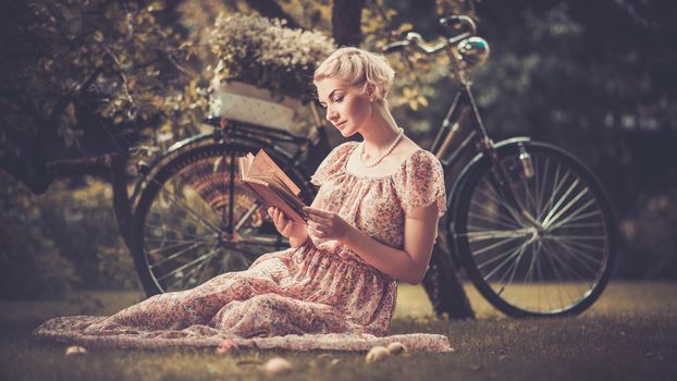 Girl with a bicycle resting in the bosom of nature Stock Photo (3)