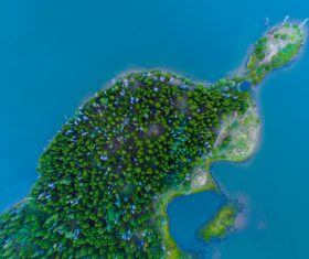 Green island on blue sea from high view Stock Photo