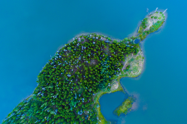 Green island on blue sea from high view Stock Photo