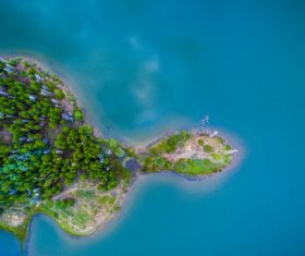 Green island on calm sea Stock Photo