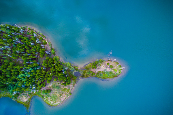 Green island on calm sea Stock Photo