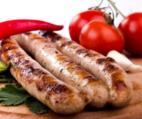 Grilled sausages and tomato peppers Stock Photo