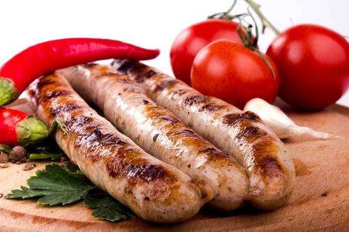Grilled sausages and tomato peppers Stock Photo