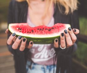 Hands holding watermelon Stock Photo
