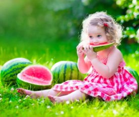 Joyful children are eating a watermelon Stock Photo (1)