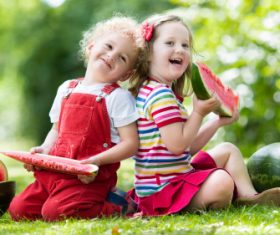 Joyful children are eating a watermelon Stock Photo (3)